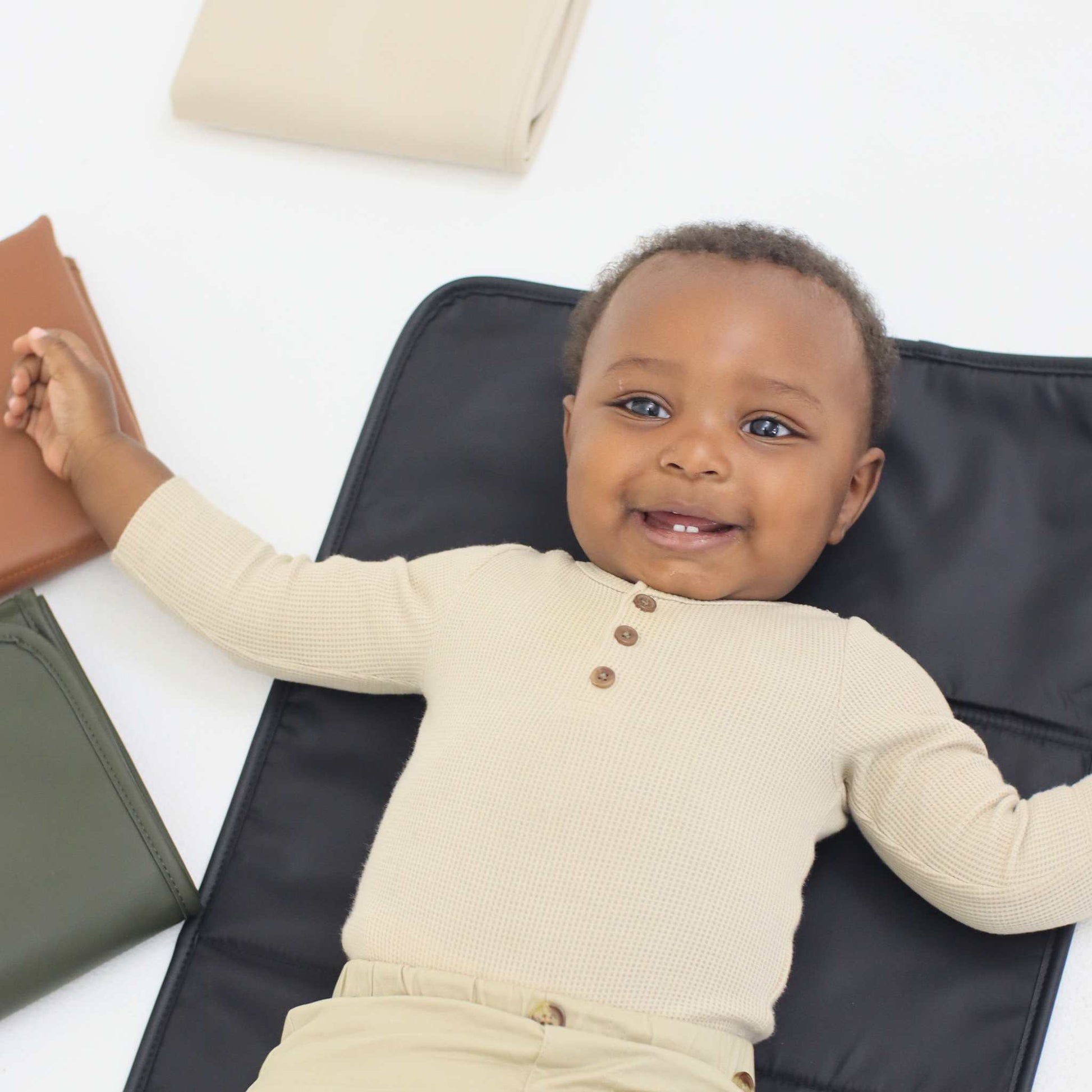 baby smiling on yuuma changing pad