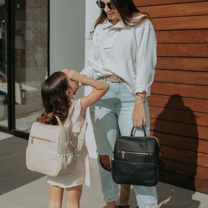 mom and daughter with mini diaper bags