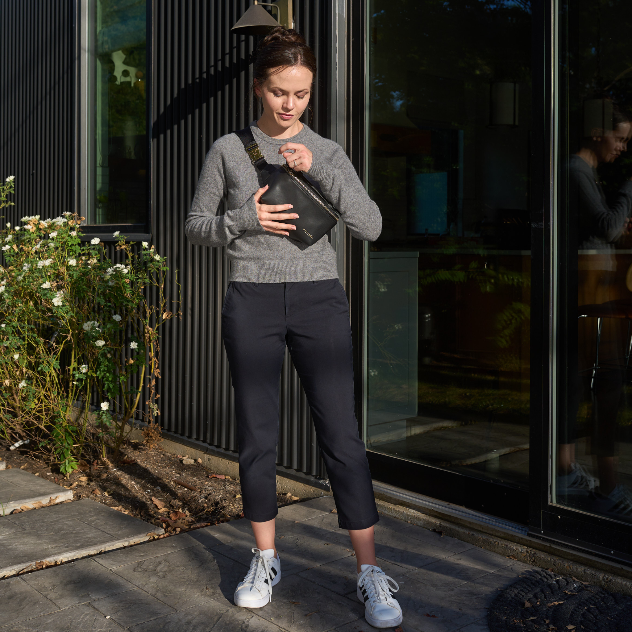 woman opening fanny pack from yuuma collection
