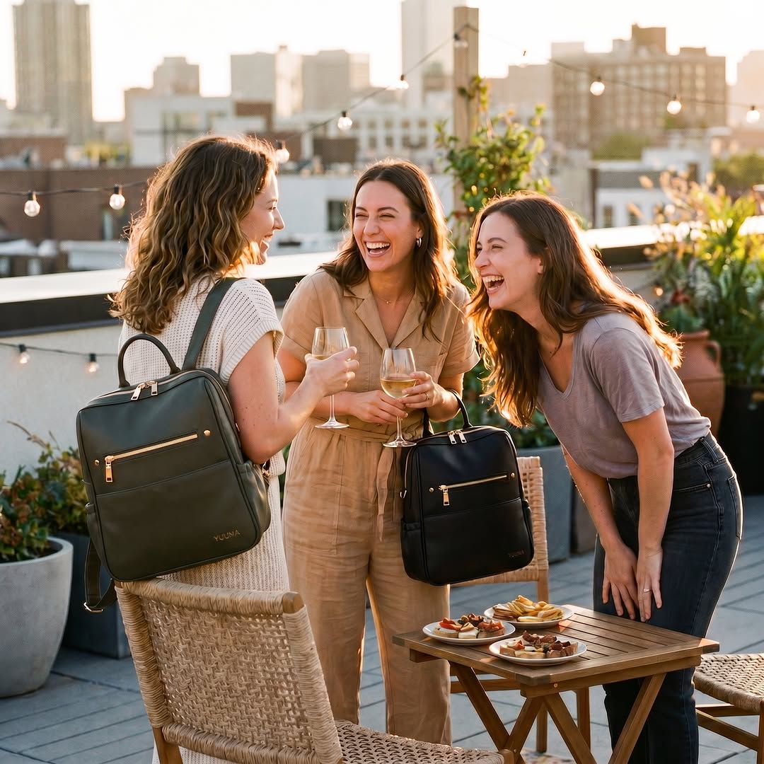 Friends together on a rooftop with their YUUMA bags