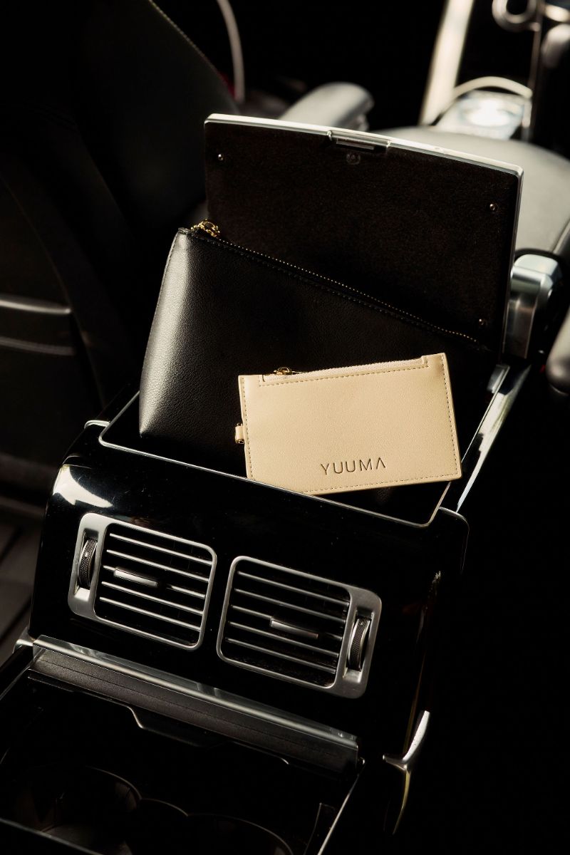 The Monet Wallet in Ivory in a car console